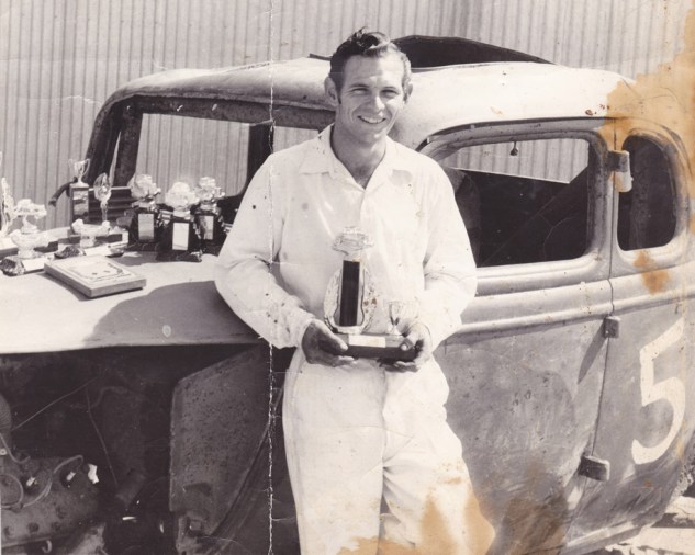 Hank at 20 in the early 1950s with trophies won at Slauson Speedway.